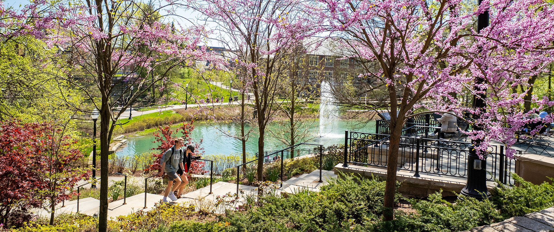 Students walk near Mirror Lake on Ohio State's Columbus campus in spring.