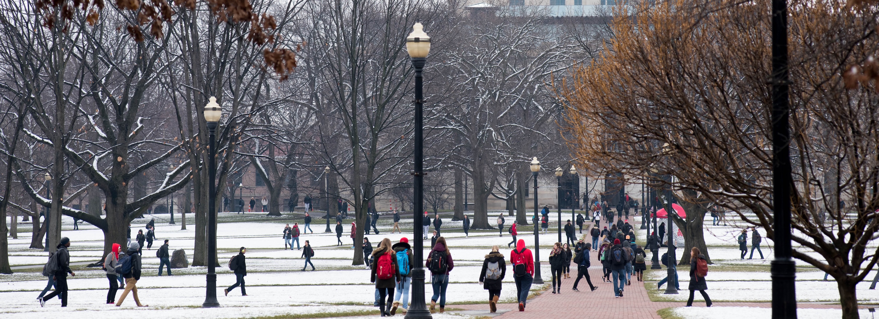 Students cross the Oval in the snow on Ohio State's Columbus campus.