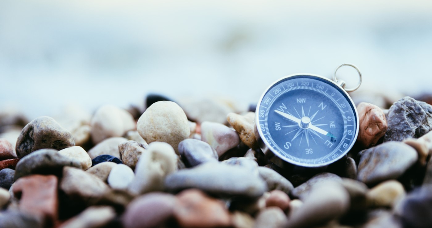 Compass on a rocky shore.