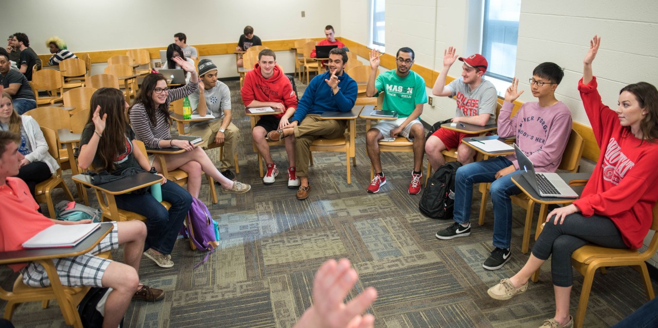 a group of students seated in a semi-circle engaged in discussion