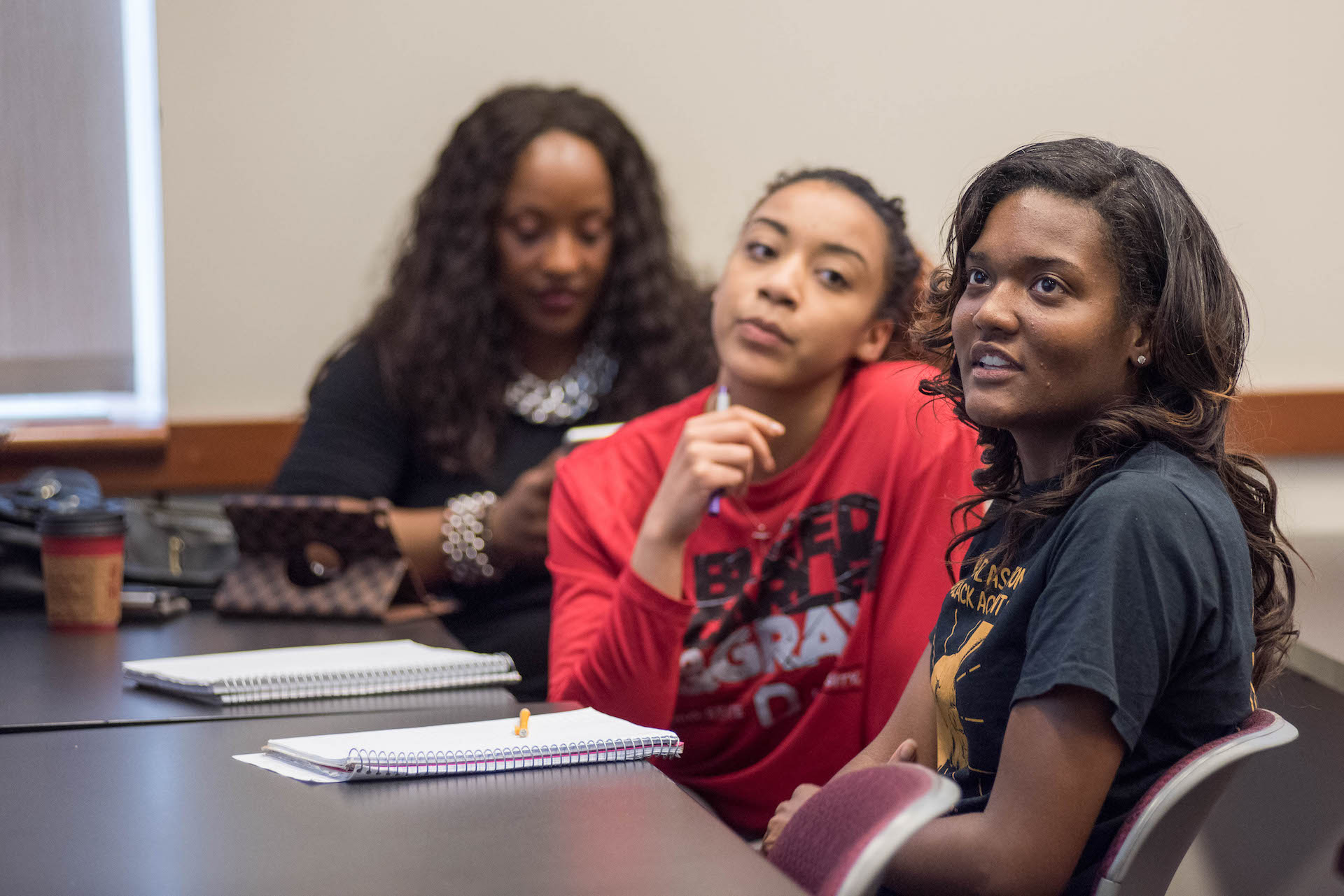 Three students contemplate the solution to a problem.