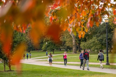 Autumn scene of students walking along a path on the main Ohio State campus Oval.