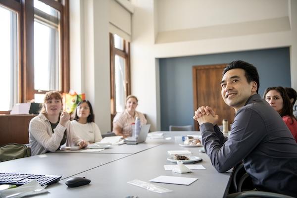 Engaged participants seated at a table.
