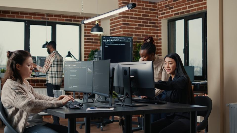 Students collaborate in a computer lab.