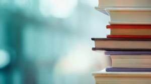 Stack of books against a blurred background.