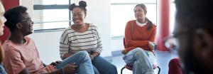 Small group of students seated in discussion.